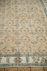 Even wear on the low pile of a distressed Sparta rug with sand, beige, and pale sky blue roundels.