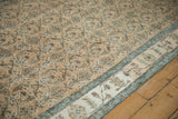 Detail of the abrashed ivory border with pale blue accents on a distressed vintage Sparta rug.