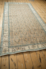 A low-angle perspective highlights the abrashed border and floral field of a vintage Sparta runner.