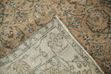 Folded corner of a vintage Sparta rug reveals its hand-knotted foundation and machine-bound edge.