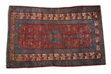 Fine vintage Malayer rug with a sapphire blue geometric medallion on a cherry red Herati field.