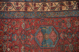 Close view of the vintage Malayer's fine weave, blue vine border, and cherry red Herati field.