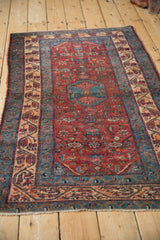 Angled perspective of a fine vintage Malayer rug, showing its central medallion and Herati field.