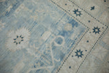 Faded powder blue and white abrash with geometric blossoms and starburst border on a vintage Oushak rug.