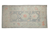 Distressed Oushak rug, pale powder blue and muted gray field with terra cotta palmettes.