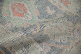 Distressed Oushak rug pile with softened patina, nuanced pale blue, terra cotta, and jade.