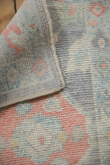 Soft hand-knotted wool pile and side cord selvage of this Oushak rug.