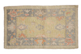 Distressed Oushak rug, tropical palmettes, softened patina in lime green, gray, and tangerine.