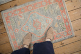 Overhead view showing the scale and soft texture of a distressed Turkish Oushak rug mat.