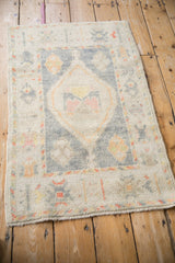Close-up on the germinating flower border of this hand-knotted Turkish Oushak rug.