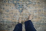 Distressed vintage Sparta rug texture; pale ochre, sapphire blue floral pattern, with feet.