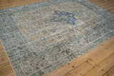 Distressed vintage Sparta carpet's pale ochre field with worn blue palmettes and exposed knot heads.