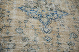 Worn pile of vintage Sparta carpet, showcasing pale ochre and blue palmette motifs.