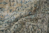 Distressed texture of vintage Turkish Sparta carpet, showing pale ochre, powder blue, and curvilinear patterns.