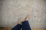 Low-pile texture of the distressed Sparta rug with blush, blue, and sage florals.