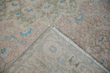 Close-up of the vintage Sparta carpet's back, showing the hand-knotted weave and secured edge.
