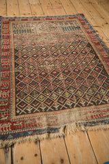 Antique Caucasian rug: blossomed geometric plant motifs, low pile, abrashed chocolate, red, blue.