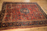 Vintage Lilihan Persian carpet: red floral field, blue vinery, visible wear to knot heads.