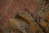 Antique Caucasian rug corner showcasing tatter, foundation exposure, and geometric pinwheel border.