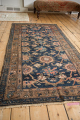 Roundel floral medallions and sprawling vines in navy, rose, and brown on vintage Hamadan runner.