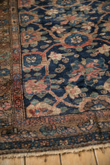 Vintage Hamadan rug corner detail, navy field, madder red border, and starburst floral motifs.