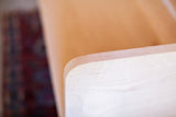 Hand-sanded rounded corner and clean lines of a modern white maple bench.