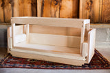 The detachable bottom of the white maple sidecar shown resting inside.