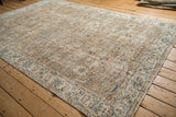 Distressed vintage Sparta carpet corner, with faded floral motifs and unique texture.