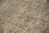 Distressed vintage Sparta carpet, showing faded floral palmettes and foundation wear.