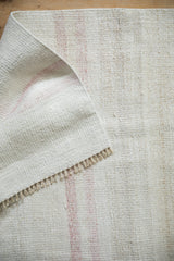 Vintage hand woven Turkish Kilim rug showing flatweave texture and short fringed edge.