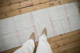 Hand woven Turkish Hemp Kilim runner with varied blush stripes on a light ivory ground.