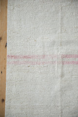 Ivory and beige hemp Kilim weave with a prominent soft rose horizontal stripe.
