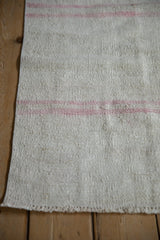 Vintage Turkish Hemp Kilim runner's hand-woven texture with blush pink and ivory horizontal stripes.