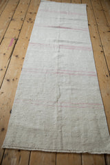 Textured weave of the vintage Turkish hemp kilim with delicate pink horizontal stripes.