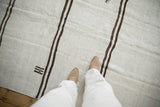 Plain-weave vintage hemp kilim with horizontal dark brown stripes and primitive stitched details.