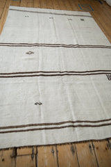 Machine-bound end of a vintage Hemp Kilim, showing beige and brown plain weave.
