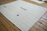 Vintage hemp kilim with a spider-like wool tuft and stitched black diamond accents.