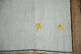 Decorative sunflower yellow tufts accenting the textured, plain-weave vintage hemp rug.