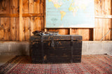Distressed black wooden trunk with chippy paint and primitive iron latch.