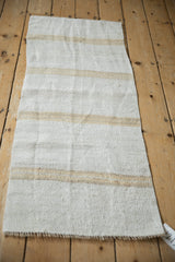 Textured plain weave of vintage hemp kilim runner with natural beige stripe and bound edge.