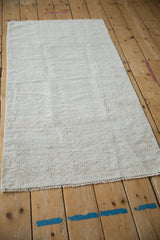 Textured plain-weave surface of the vintage Turkish hemp kilim, in platinum and beige tones.