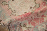 Hand-knotted texture and even, low pile of a distressed vintage rug in rose, silver, and brown.