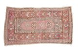Distressed vintage Oushak rug with faded plum cartouche medallions and brown geometric borders.