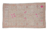 Vintage distressed Oushak rug with a geometric floral pattern in platinum and dusty blush with bright magenta accents.