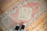 Distressed vintage Oushak runner, faded raspberry and sea foam green, with unique texture.