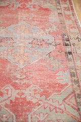 Distressed Oushak texture with worn cherry red, dusty blue and green motifs.