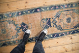 Oushak runner texture, with distressed sand, cobalt blue, and pink geometric patterns.