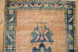 Distressed Oushak rug runner with worn sand field and geometric cobalt blue border.