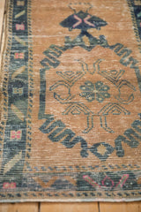 Distressed Oushak runner, close-up of worn pile and foundation, with sand, blue, pink.