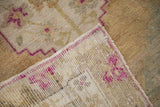 The reverse of a vintage Oushak rug, detailing its hand-knotted foundation and weave.